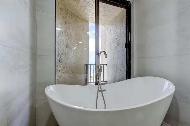 a white bath tub sitting in a bathroom