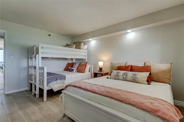 a bedroom with a bed and a night stand