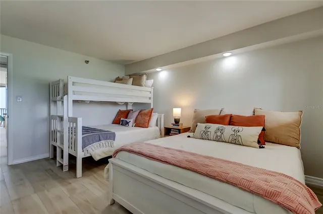 a bedroom with a bed and a night stand