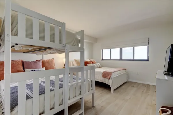 a bedroom with furniture and a flat screen tv