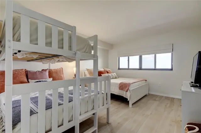 a bedroom with furniture and a flat screen tv