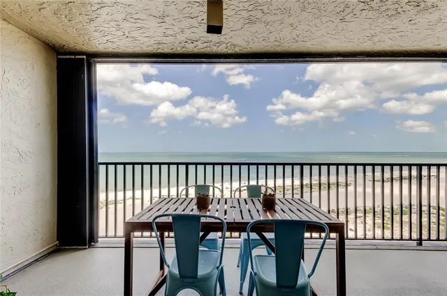 a view of a chair and table in the balcony