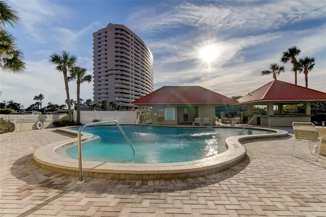 swimming pool view with a seating space