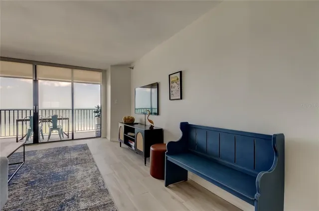 a living room with furniture and a floor to ceiling window