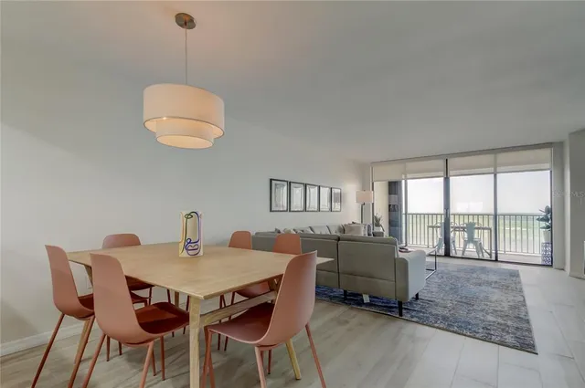 a view of a dining room with furniture wooden floor and chandelier