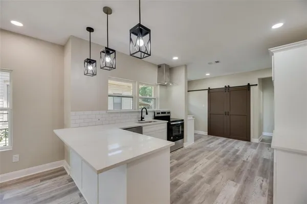 a view of a kitchen and a refrigerator