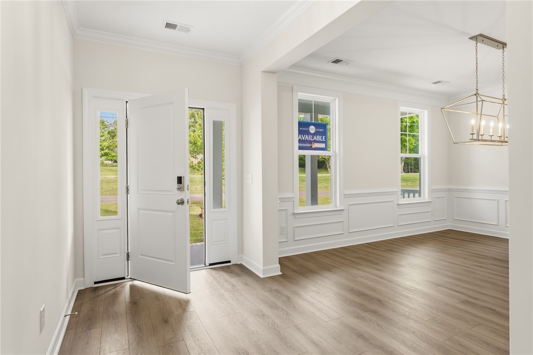 1108 Manse Jolly Road Anderson, SC 29621 - Photo 3 of 45 This bright entry opens into a versatile room, showcasing elegant wainscoting and natural light.