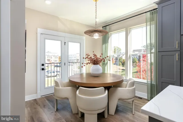 a dining room with furniture window and wooden floor