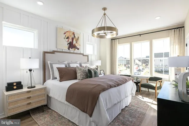 a bedroom with bed and a chandelier