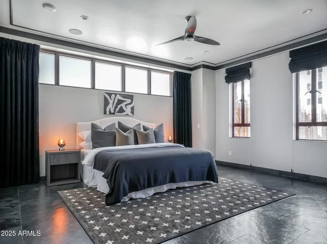 a spacious bathroom with a granite countertop tub and a large window