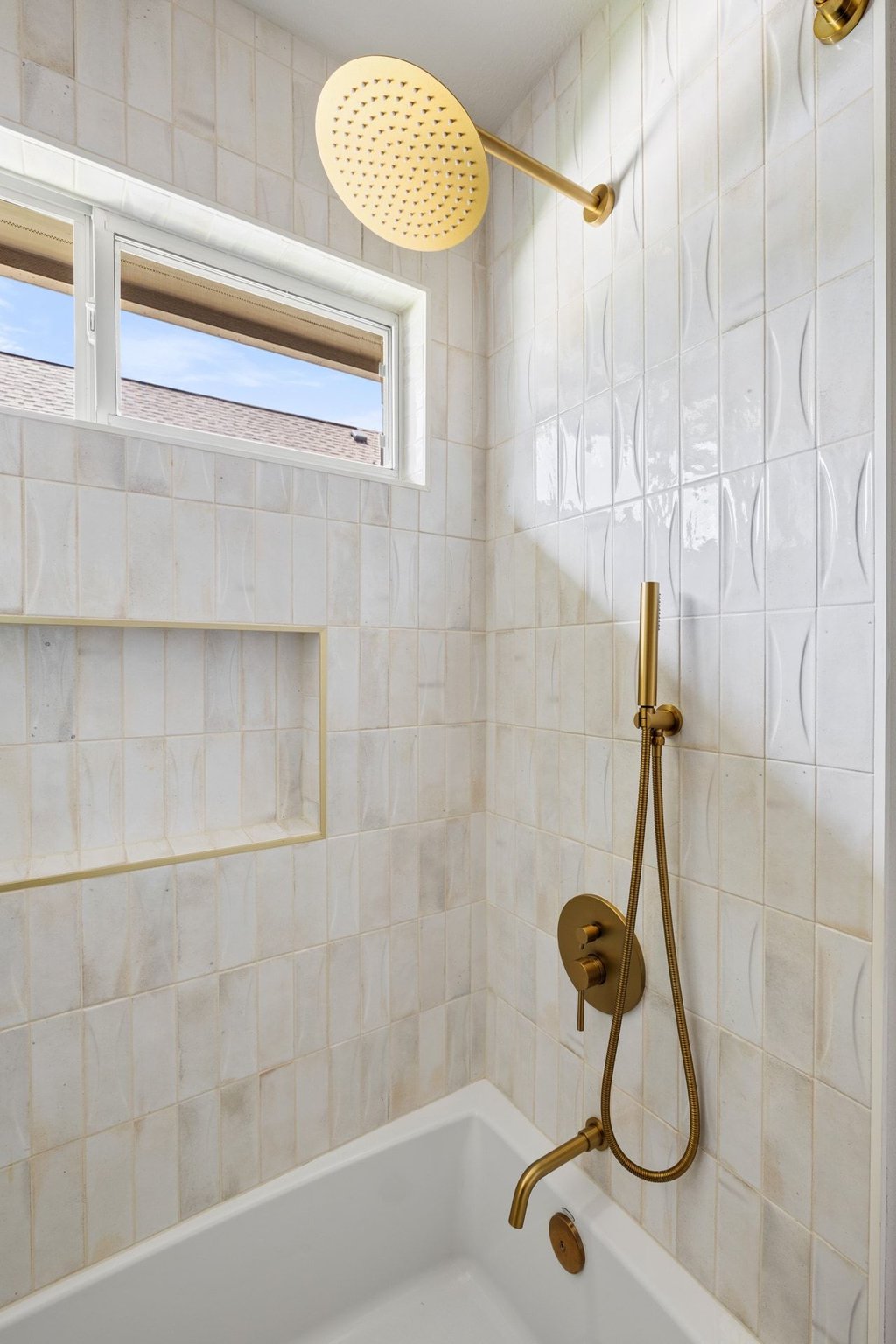6704 Kiev Cove Austin, TX 78739 - Photo 26 of 37 A rain shower head and a built-in shelf complement this well-appointed bath.