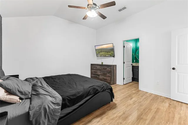 a bedroom with a bed and ceiling fan