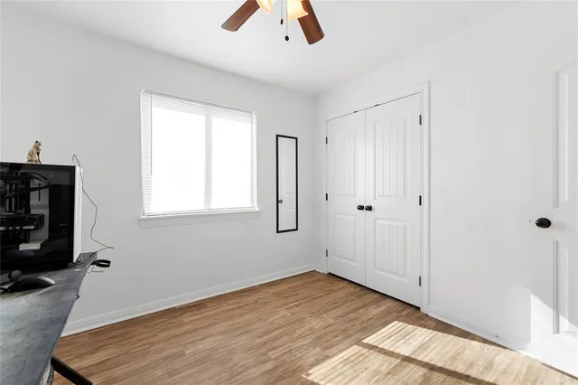 a view of livingroom with hardwood floor and a ceiling fan