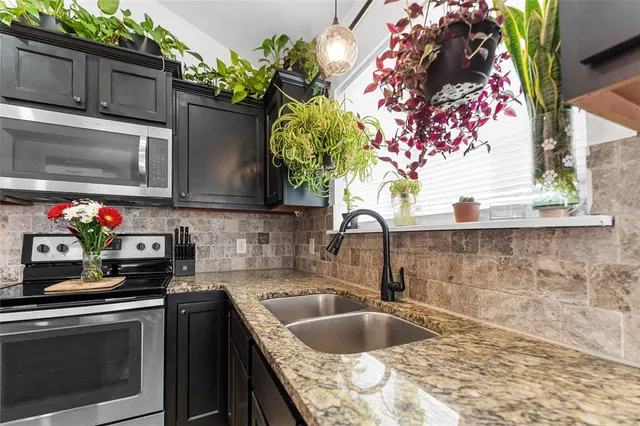 a kitchen with a sink and a stove
