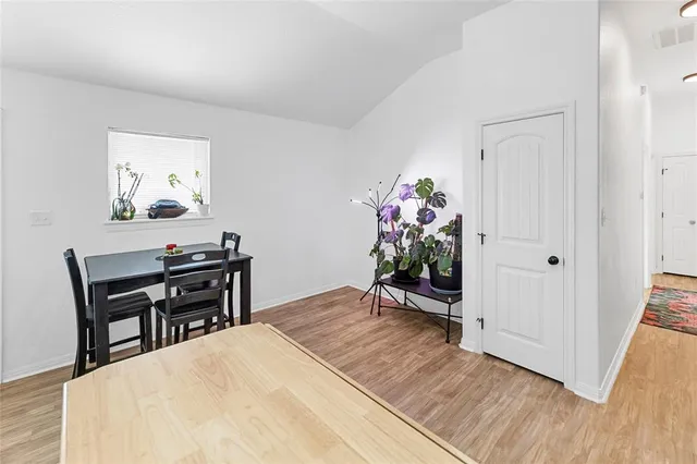 a view of a workspace with furniture and wooden floor