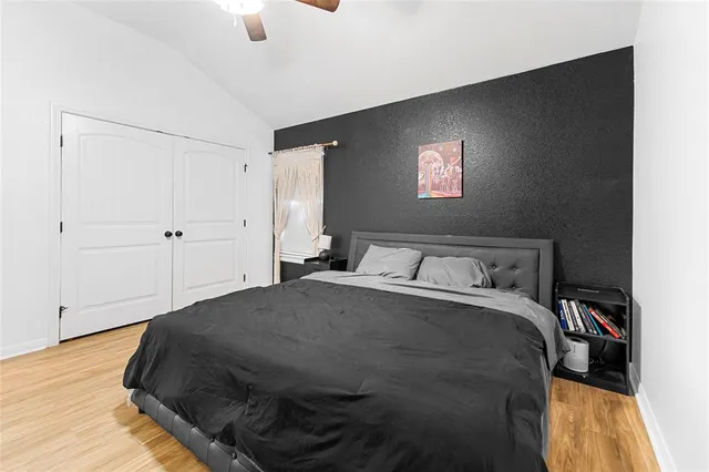 a bedroom with a bed and a chandelier