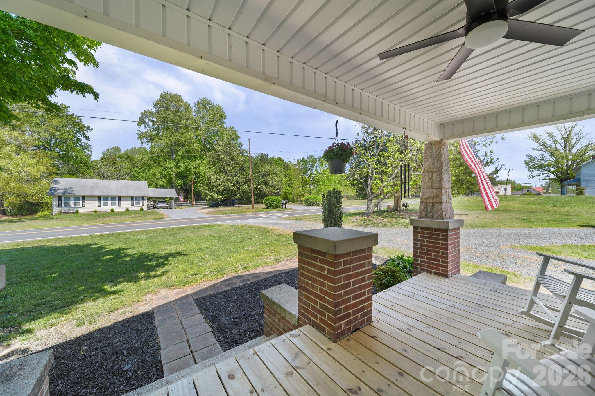 9215 Stokes Ferry Road Salisbury, NC 28146 - Photo 17 of 22 a view of a patio with table and chairs potted plants with wooden floor
