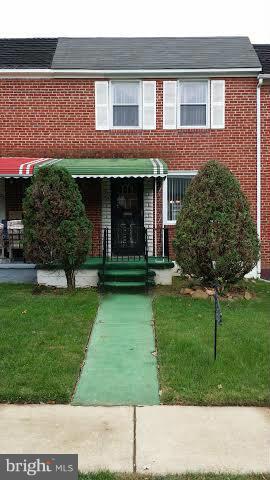 1224 Kevin Road Baltimore, MD 21229 - Photo 1 of 11 a view of a brick house with a yard