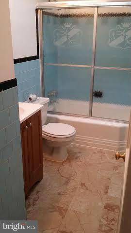 1224 Kevin Road Baltimore, MD 21229 - Photo 5 of 11 a bathroom with a toilet and a shower