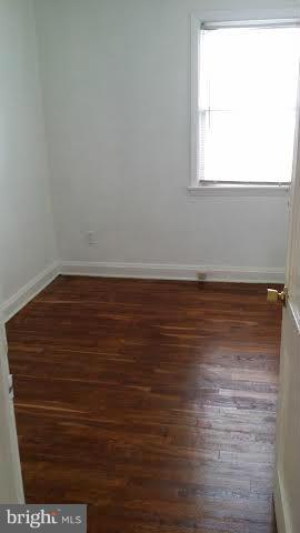 1224 Kevin Road Baltimore, MD 21229 - Photo 8 of 11 a view of a room with wooden floor and a window