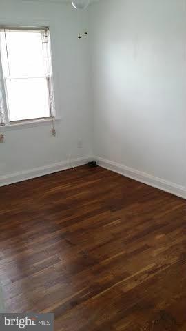 1224 Kevin Road Baltimore, MD 21229 - Photo 9 of 11 an empty room with wooden floor and windows