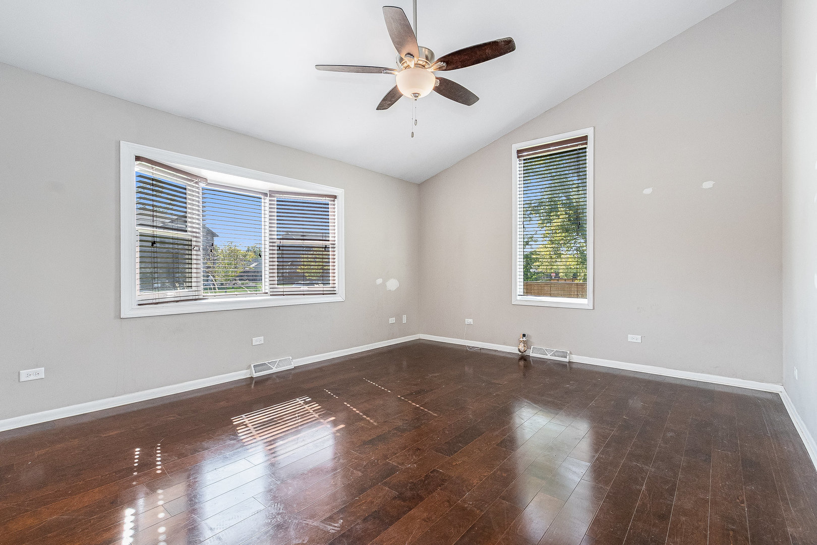 311 West Michigan Road New Lenox, IL 60451 - Photo 2 of 16 a view of an empty room with a window and wooden floor