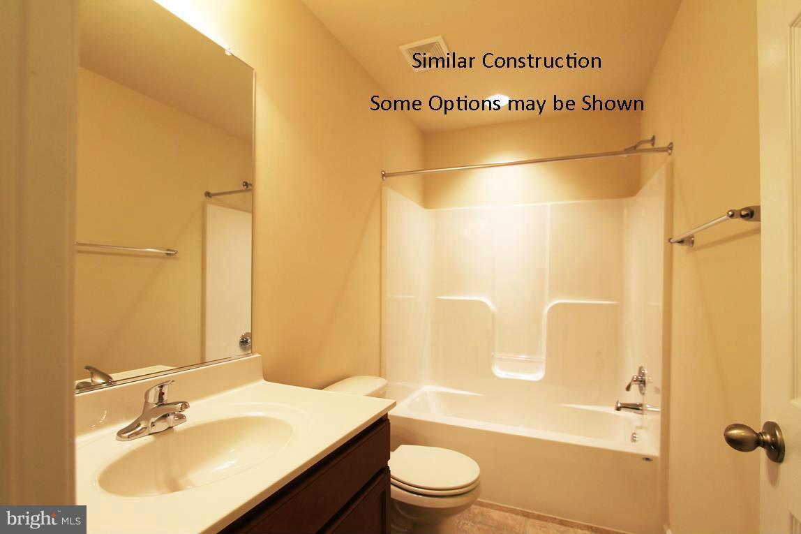 0 Stallion Street, Unit 410 Ranson, WV 25438 - Photo 22 of 30 a bathroom with a sink mirror toilet and bathtub