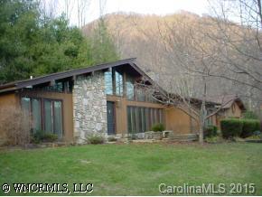 115 Laurel Branch Road Maggie Valley, NC 28751 - Photo 1 of 8 a view of a wooden house with a yard