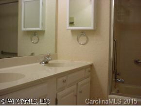 115 Laurel Branch Road Maggie Valley, NC 28751 - Photo 6 of 8 a bathroom with a granite countertop sink and a mirror