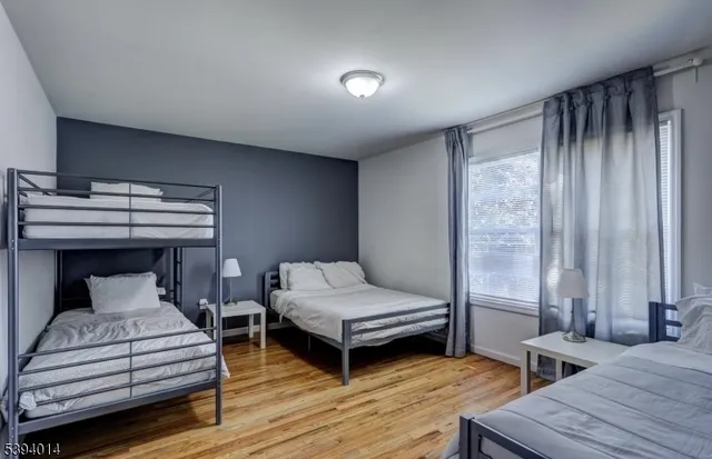 a bedroom with two beds and a chandelier
