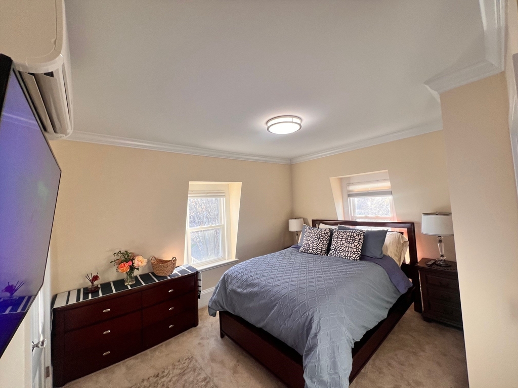 17 Emerson Street, Unit 2 Wakefield, MA 01880 - Photo 12 of 22 a bedroom with a bed and window