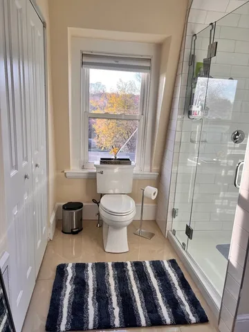 a bathroom with a toilet and a shower