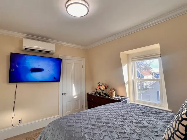 a bedroom with a bed and window