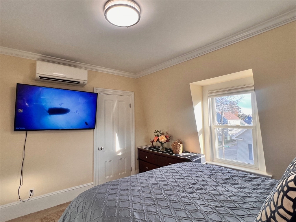 17 Emerson Street, Unit 2 Wakefield, MA 01880 - Photo 17 of 22 a bedroom with a bed and window