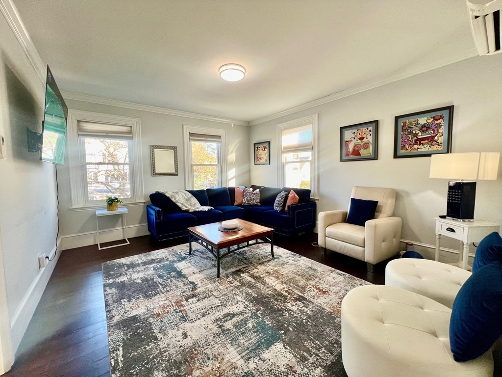 17 Emerson Street, Unit 2 Wakefield, MA 01880 - Photo 8 of 22 a living room with furniture wooden floor and windows