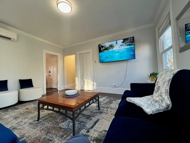 a living room with furniture and a rug