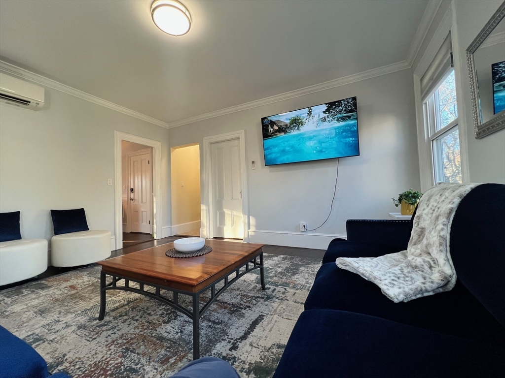 17 Emerson Street, Unit 2 Wakefield, MA 01880 - Photo 9 of 22 a living room with furniture and a rug