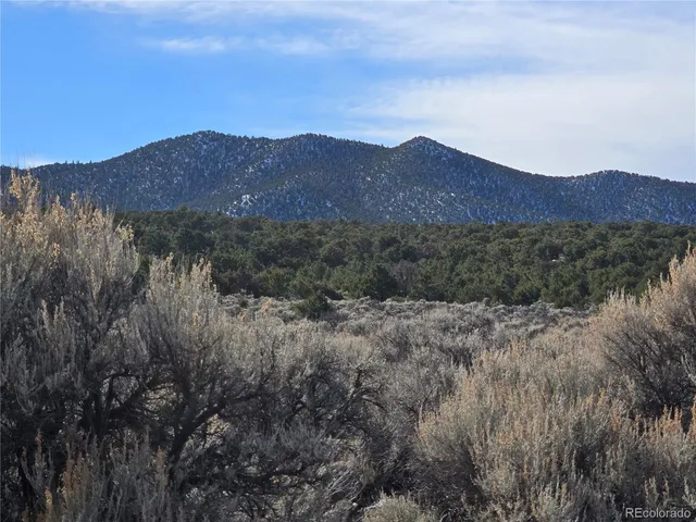 a view of mountains and valleys in the distance in the background