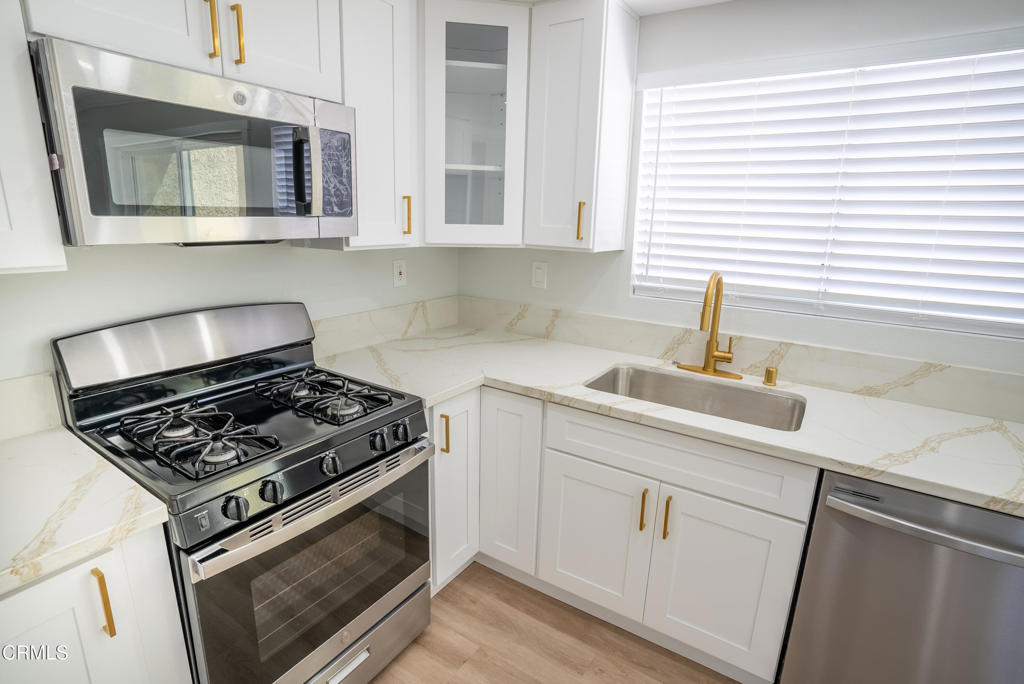 5233 Perkins Road Oxnard, CA 93033 - Photo 1 of 1 a kitchen with white cabinets and appliances