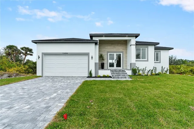 a front view of a house with a garden and yard