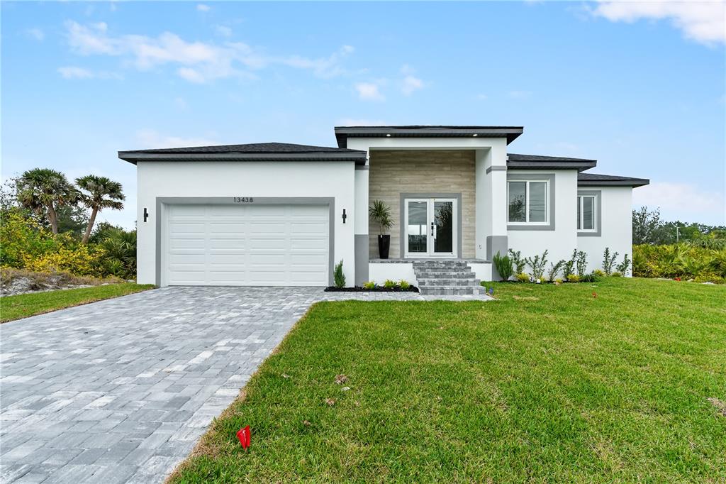 a front view of a house with a garden and yard