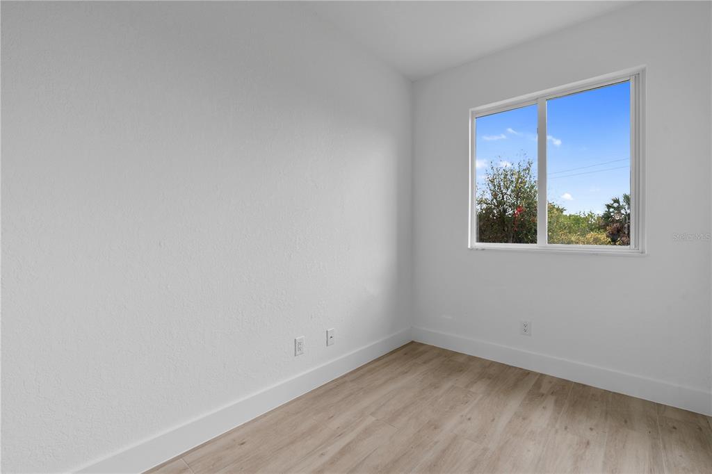 13438 Mc Intosh Avenue Port Charlotte, FL 33981 - Photo 15 of 46 a view of an empty room with a window