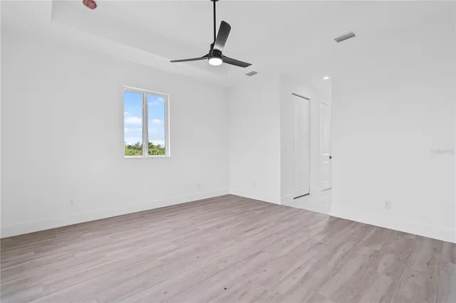 wooden floor in an empty room with a window