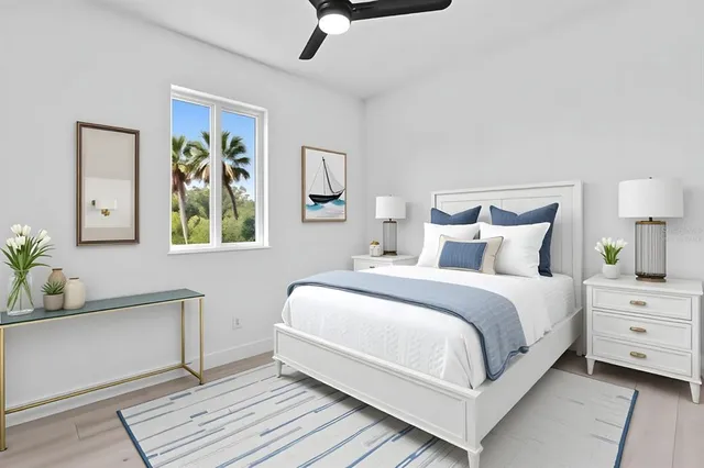 a bedroom with a bed and painting on the wall