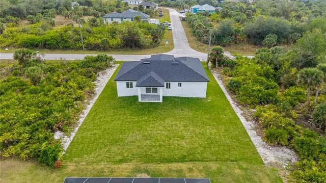 an aerial view of residential houses with outdoor space and lake view
