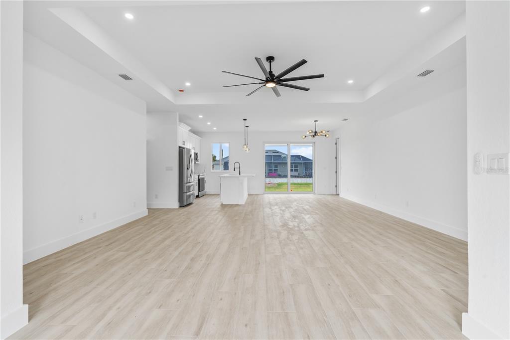 13438 Mc Intosh Avenue Port Charlotte, FL 33981 - Photo 4 of 46 a view of a livingroom with a ceiling fan & hardwood floor