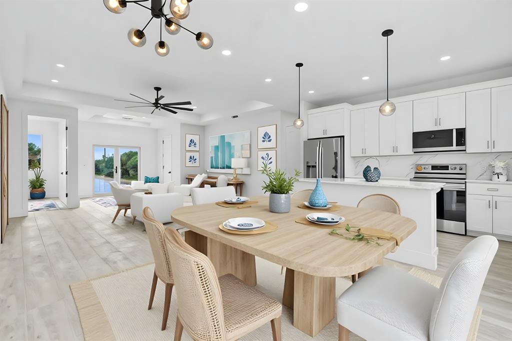 13438 Mc Intosh Avenue Port Charlotte, FL 33981 - Photo 6 of 46 a view of a dining room with furniture a kitchen and chandelier