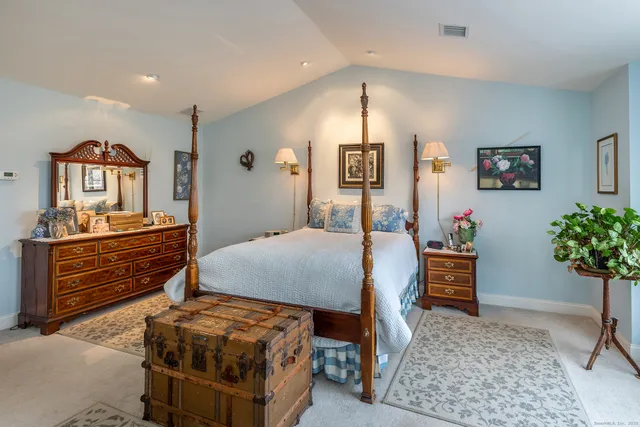 a bedroom with a bed and a dresser in it