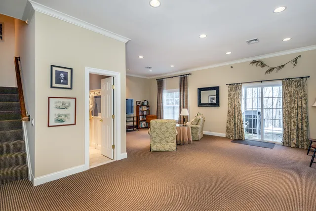 a living room with furniture and large windows