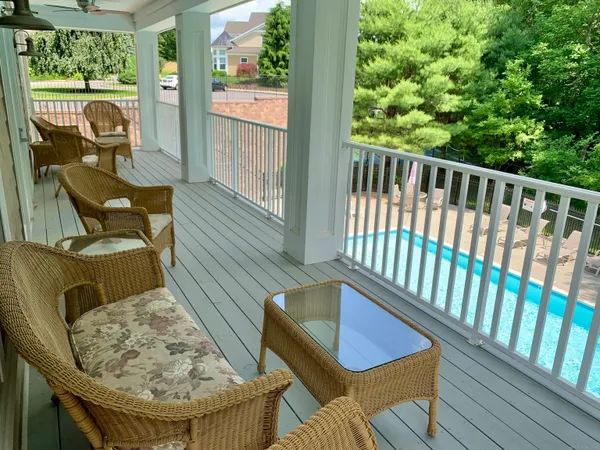 a view of a chairs and table in the balcony